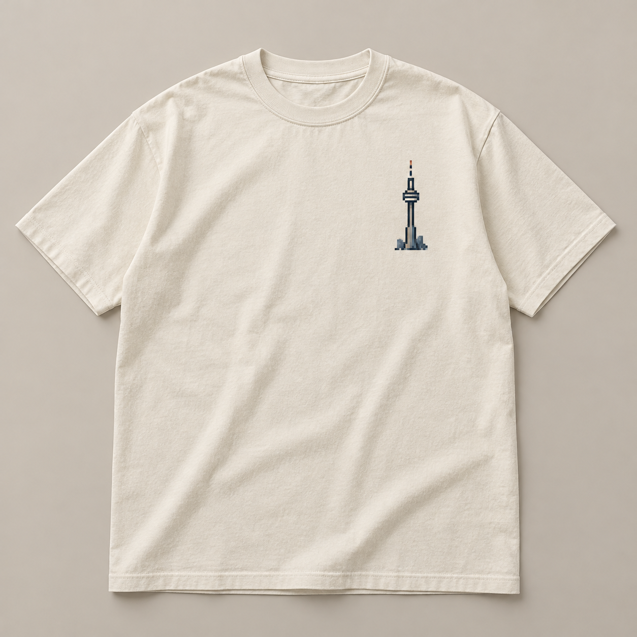 Cream T-shirt with a small pixel CN Tower chest graphic